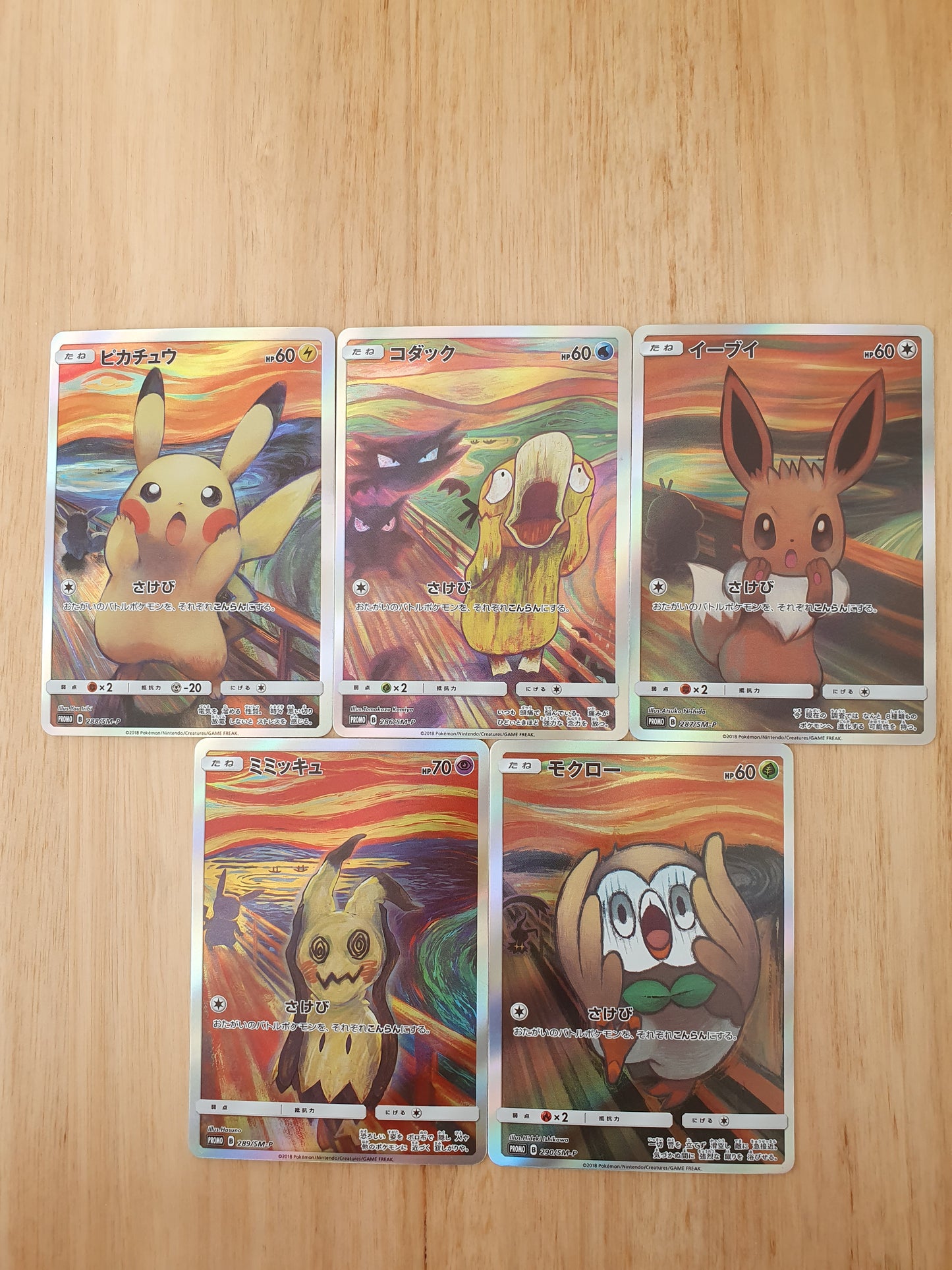 A set of five custom-made Pokémon cards featuring characters such as Pikachu, Eevee, and others, with a colorful abstract background.